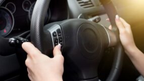 Female hands on steering wheel